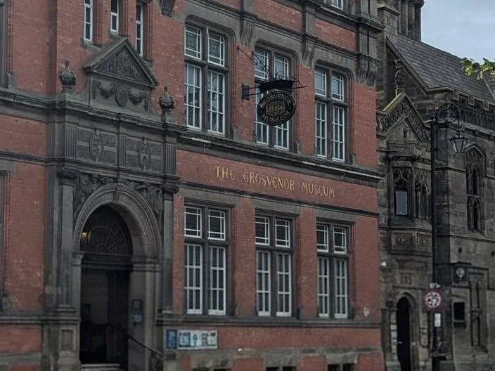 The arched doorway and gold lettered sign of the Grosvenor Museum