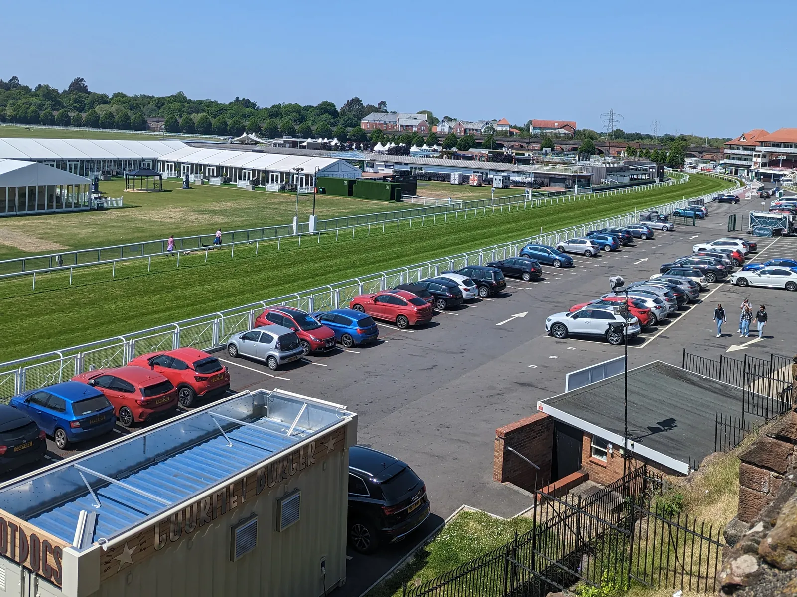 The green track and white marquees at Chester Racecourse in summer