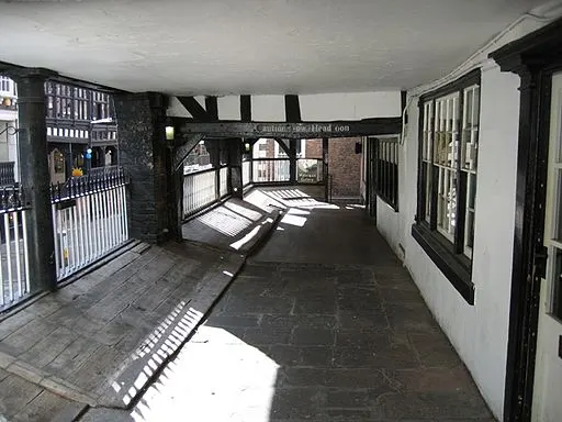 The covered medieval walkway of the Chester Rows in low sunlight
