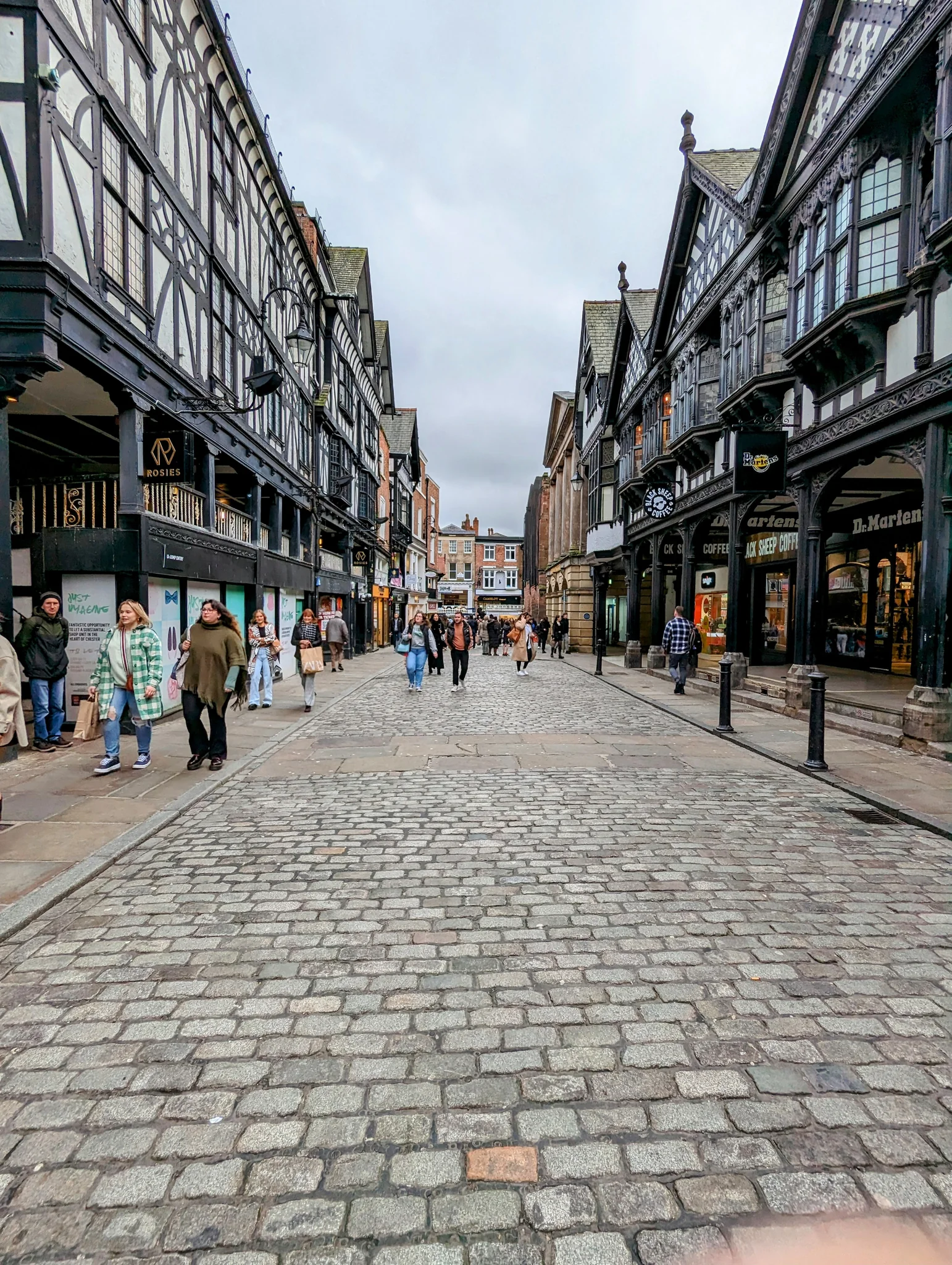 Chester's black-and-white Rows above a cobbled shopping street in spring