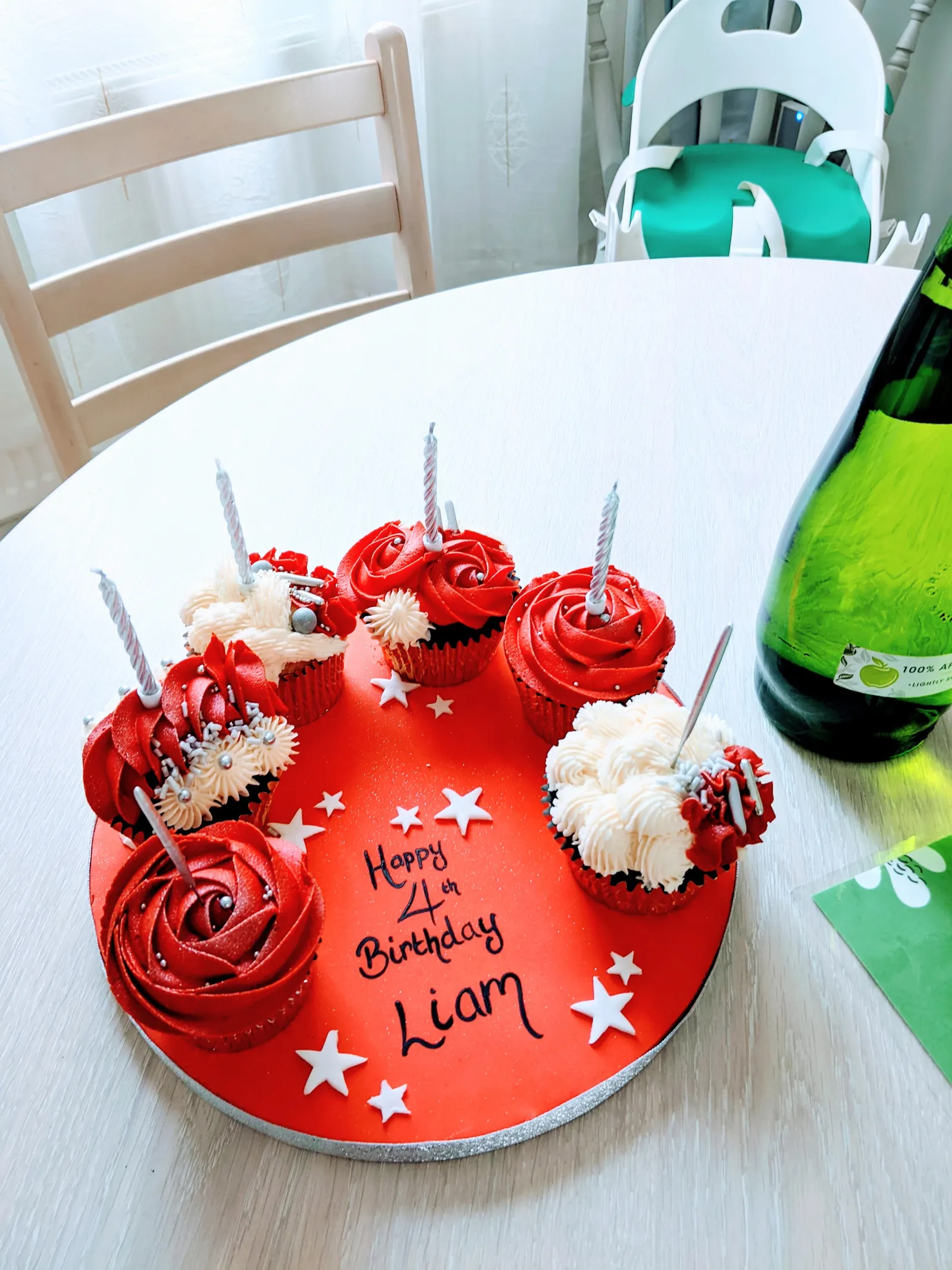 Red rose birthday cake with candles set up on the dining table