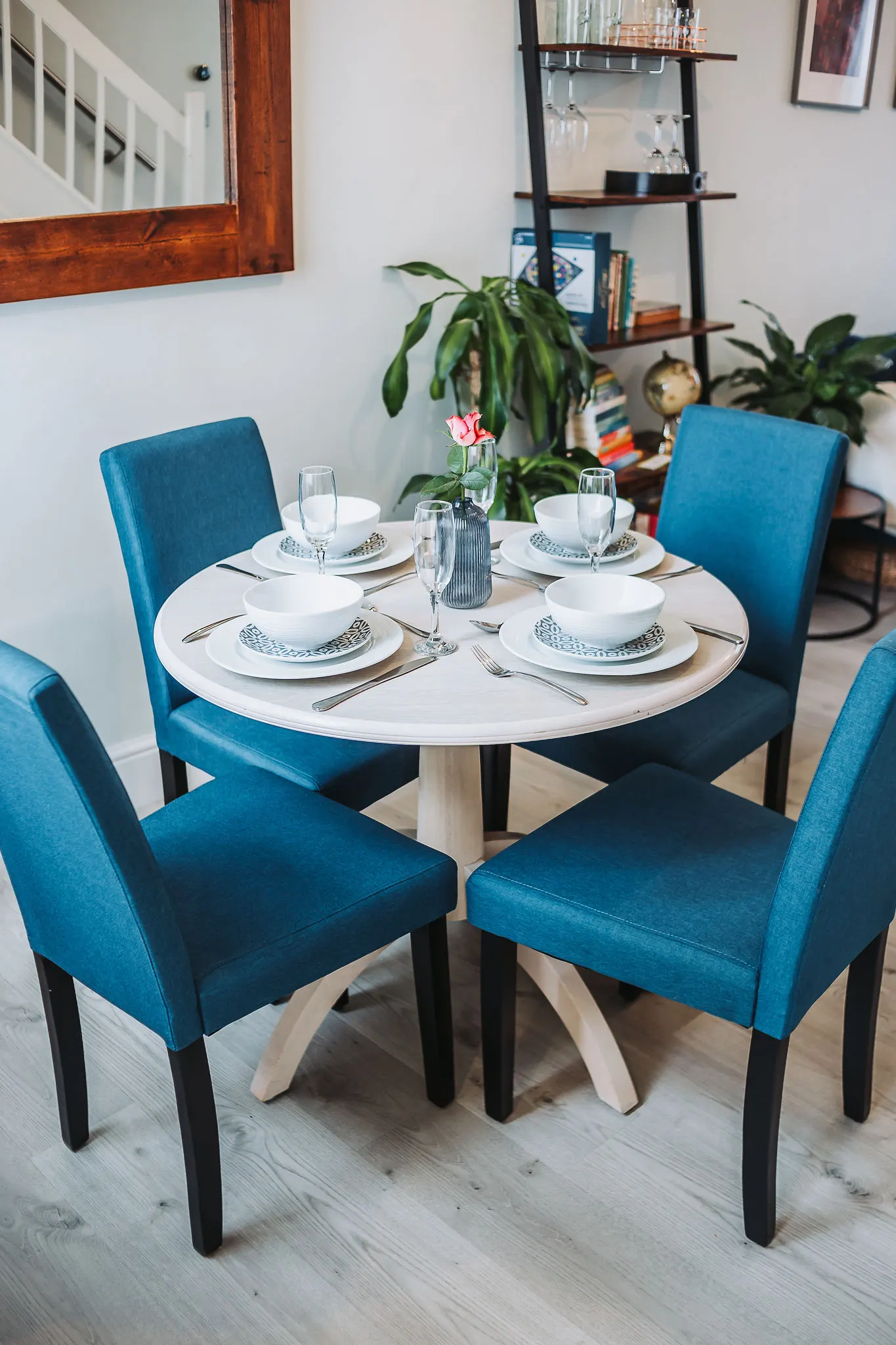 Dining table laid for four with bowls, plates and glasses