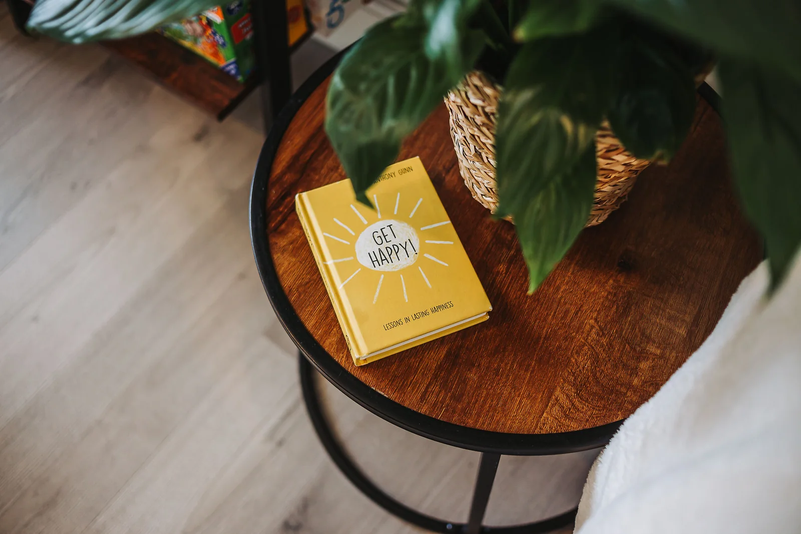 Lounge side table with a cheerful book and trailing houseplant