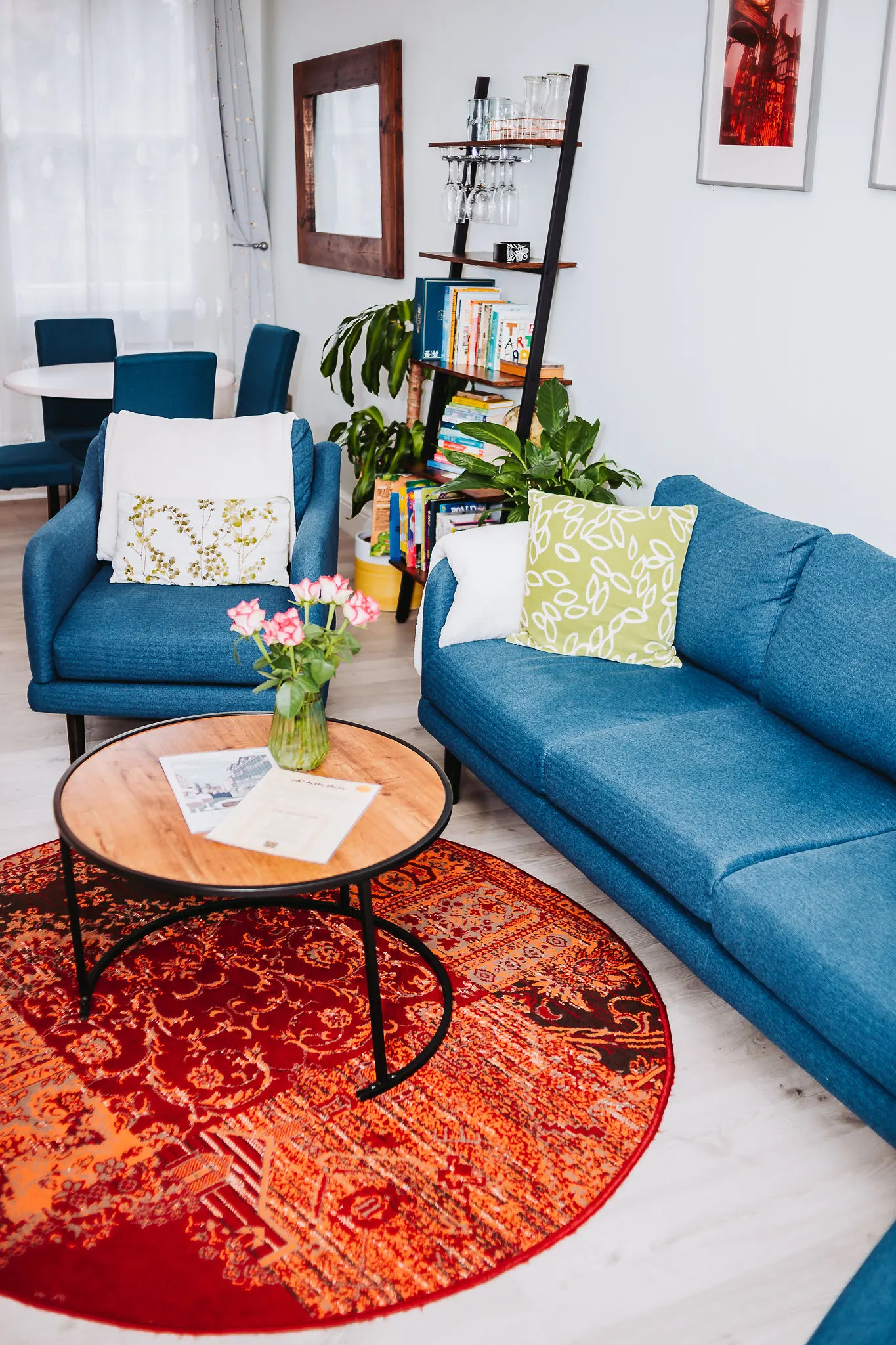 Blue sofa with cushions and fresh flowers on the coffee table