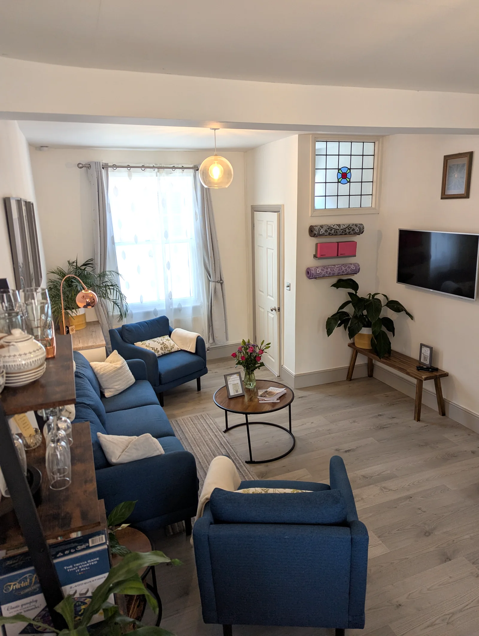 Lounge with wall-mounted television, reading corner and yoga mats