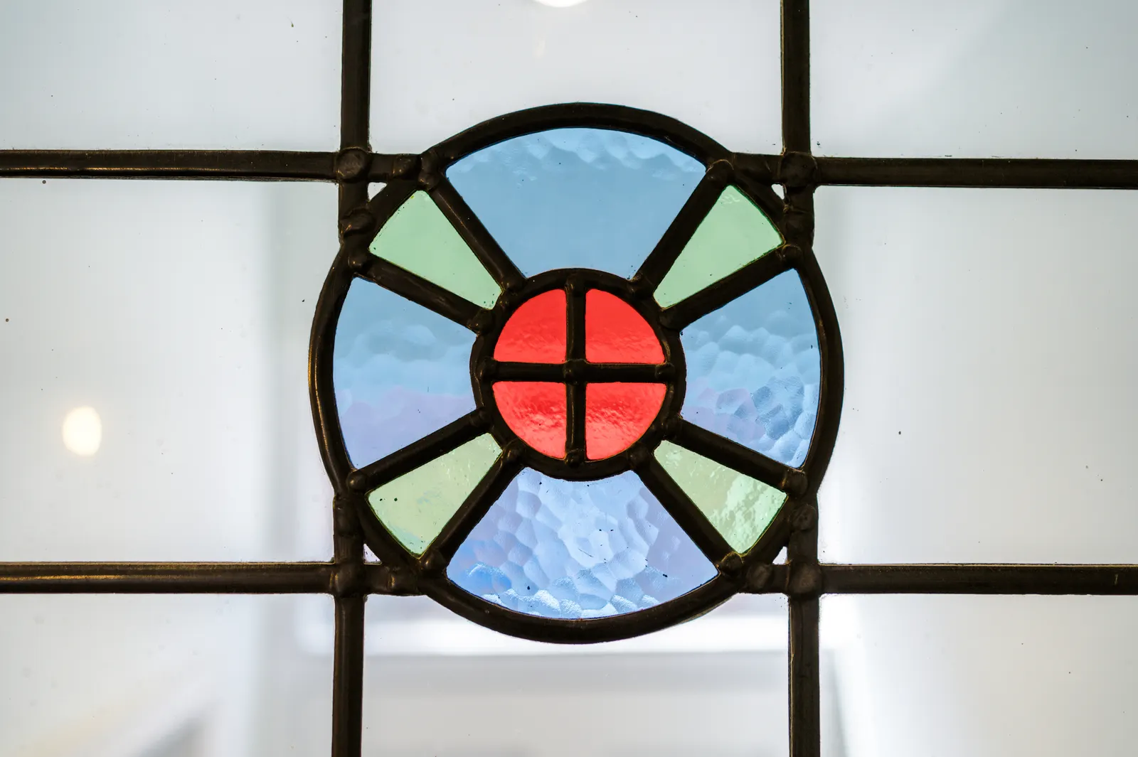 Original stained-glass window detail in blue, green and red