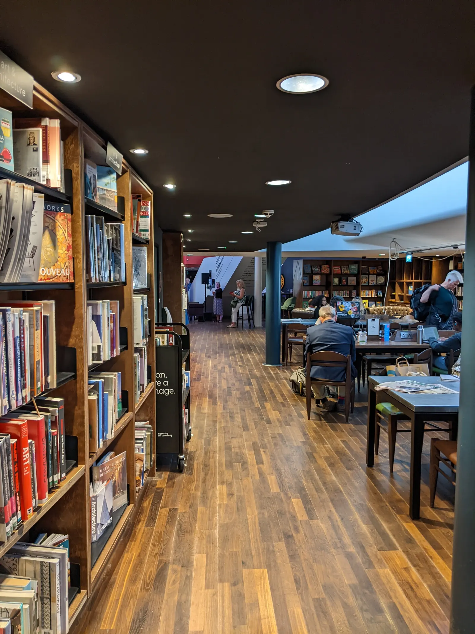 Bookshelves and cafe seating inside Storyhouse, Chester's arts centre